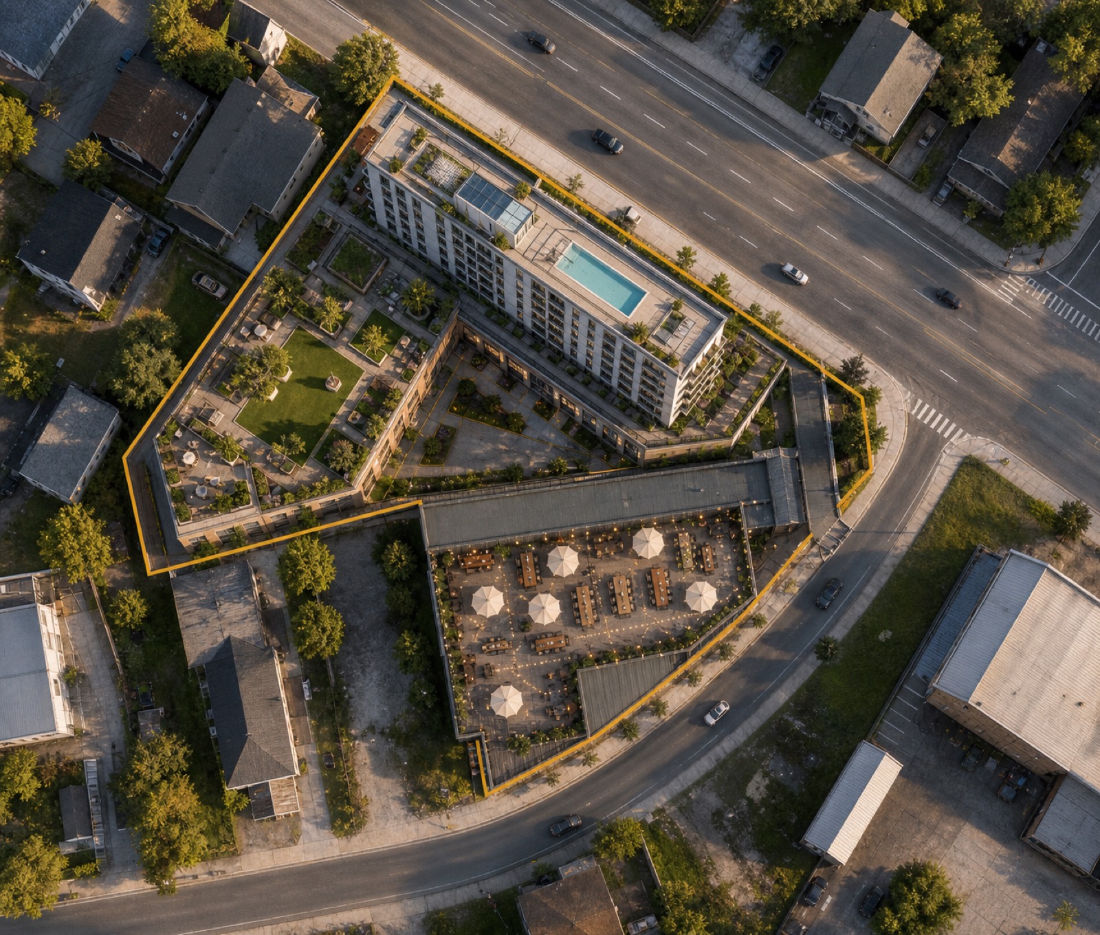 Top-down concept site rendering matching the parcel plat: residential bar with rooftop pool along the N Main frontage, landscaped amenity terrace to the west, and the brewery's open-air event roof tapering along North St to the crossing